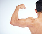 Bodybuilder, muscle and closeup of bicep in studio for gym, fitness or wellness by blue background. Model, growth or development for strong, healthy flex or exercise in workout, training or body goal