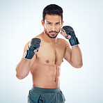 Face portrait, mma sports and man in studio on a blue background. Martial arts, body fitness and serious male fighter or boxer ready for training, workout or exercise for battle, match or competition