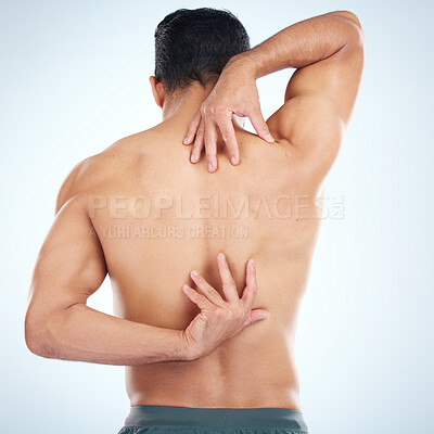 Buy stock photo Man, body or stretching back muscles on blue background in studio pain relief, healthcare wellness or burnout tension release. Sports athlete, fitness model or coach flexing in workout success check