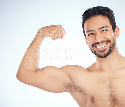 Portrait, fitness or man in studio to flex muscle or strong arms training  biceps in workout or exercise. Face, happy smile or healthy bodybuilder  with growth mindset, motivation or wellness goals