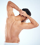 Man, body or stretching back muscles on blue background in studio pain relief, healthcare wellness or burnout tension release. Sports athlete, fitness model or coach flexing in workout success check