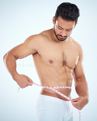 Buy stock photo Man, body or measuring tape on waist on studio background for weight loss management, fat control or bmi healthcare wellness. Fitness model, sports athlete or coach with tape measure for muscle goals