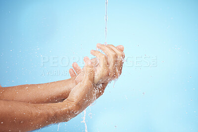 Buy stock photo Man, water or washing hands on blue background for body hygiene maintenance, healthcare wellness or skincare grooming routine. Model, water splash or running shower for cleaning bacteria or self care