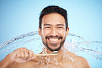 Water splash, portrait or man brushing teeth in studio with toothbrush for white teeth or oral healthcare. Face, tooth paste or happy person cleaning or washing mouth with a healthy dental smile