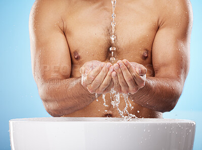 Buy stock photo Man, water or washing hands on blue background for body hygiene maintenance, healthcare wellness or skincare grooming routine. Model, water splash or running shower for cleaning bacteria or self care