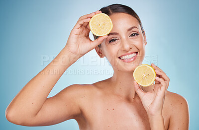 Buy stock photo Woman, lemon and smile portrait for natural beauty wellness, health product and cosmetics dermatology care in blue background studio. Model happiness, vitamin c detox and luxury facial self care