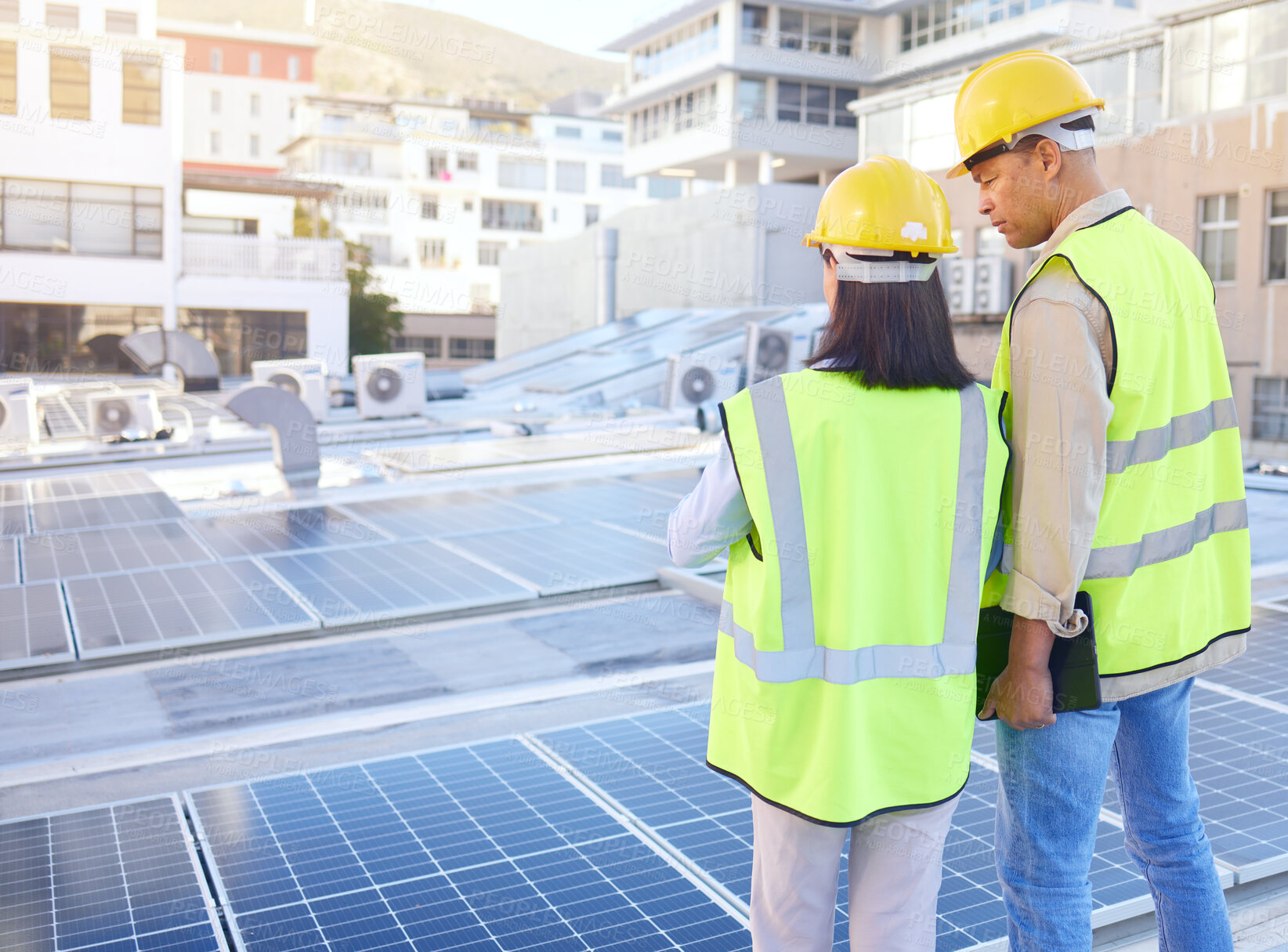 Buy stock photo Engineer, back or woman with man, solar energy or sustainable power inspection. Technician, male or female for panels maintenance, eco friendly construction or agriculture for alternative electricity
