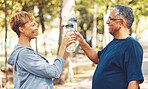 Water, happy or old couple in nature for fitness training, workout challenge target or exercise goals. Toast, cheers or or senior woman hiking, walking or exercising with mature partner in a park
