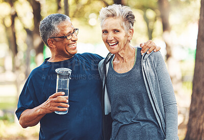 Buy stock photo Exercise, senior couple in park and water bottle for training, workout and smile. Mature man, elderly woman and hydration for practice, cardio and energy for wellness, health and fitness in nature.