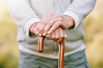 Buy stock photo Hands, elderly and retirement, man with walking stick outdoor for walk with fitness and vitality, disability or old age. Old man with cane for support, active lifestyle and wellness in the park.