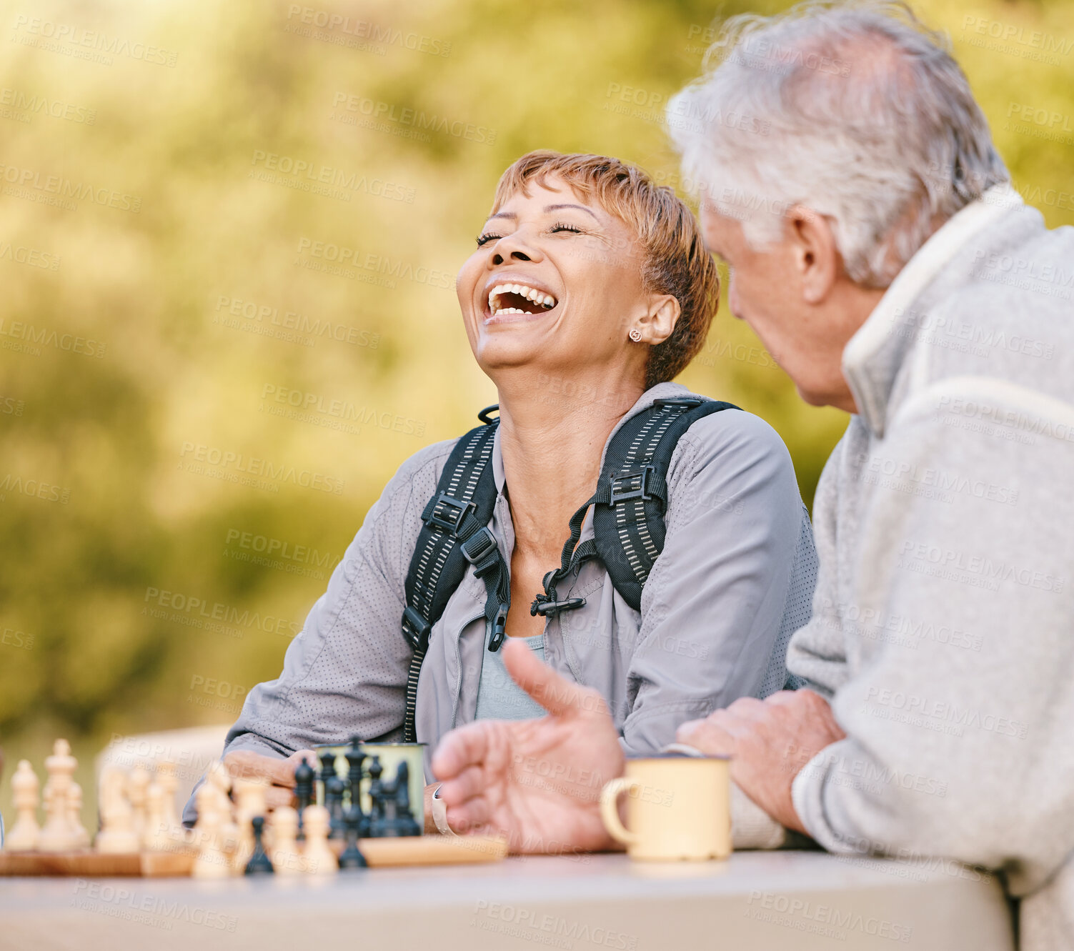 Buy stock photo Happy, chess or couple of friends in nature playing a board game, bonding or talking about a funny story. Park, support or healthy senior people laughing at a joke and enjoying quality relaxing time 