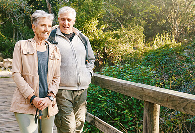 Buy stock photo Senior hiking couple, bridge and nature on outdoor adventure, summer sunshine or bonding together. Elderly man, old woman and happiness with smile, love or walking in woods, forest or park for health