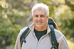 Hiking, fitness and elderly man in nature for exercise and trekking in the park, vitality and active lifestyle portrait. Senior hiker, travel and adventure with retirement and wellness with cardio.