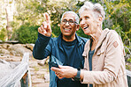 Relax, senior or couple of friends hiking, walking or trekking for freedom, exercise or fitness in nature forest. Interracial, travel or happy woman enjoys bonding time with healthy elderly partner