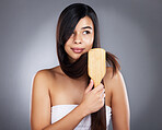Woman, brush and hair care for beauty, wellness and self care by studio background with natural shine. Model, hair and self love with organic wooden hairbrush for sustainable cosmetics by backdrop