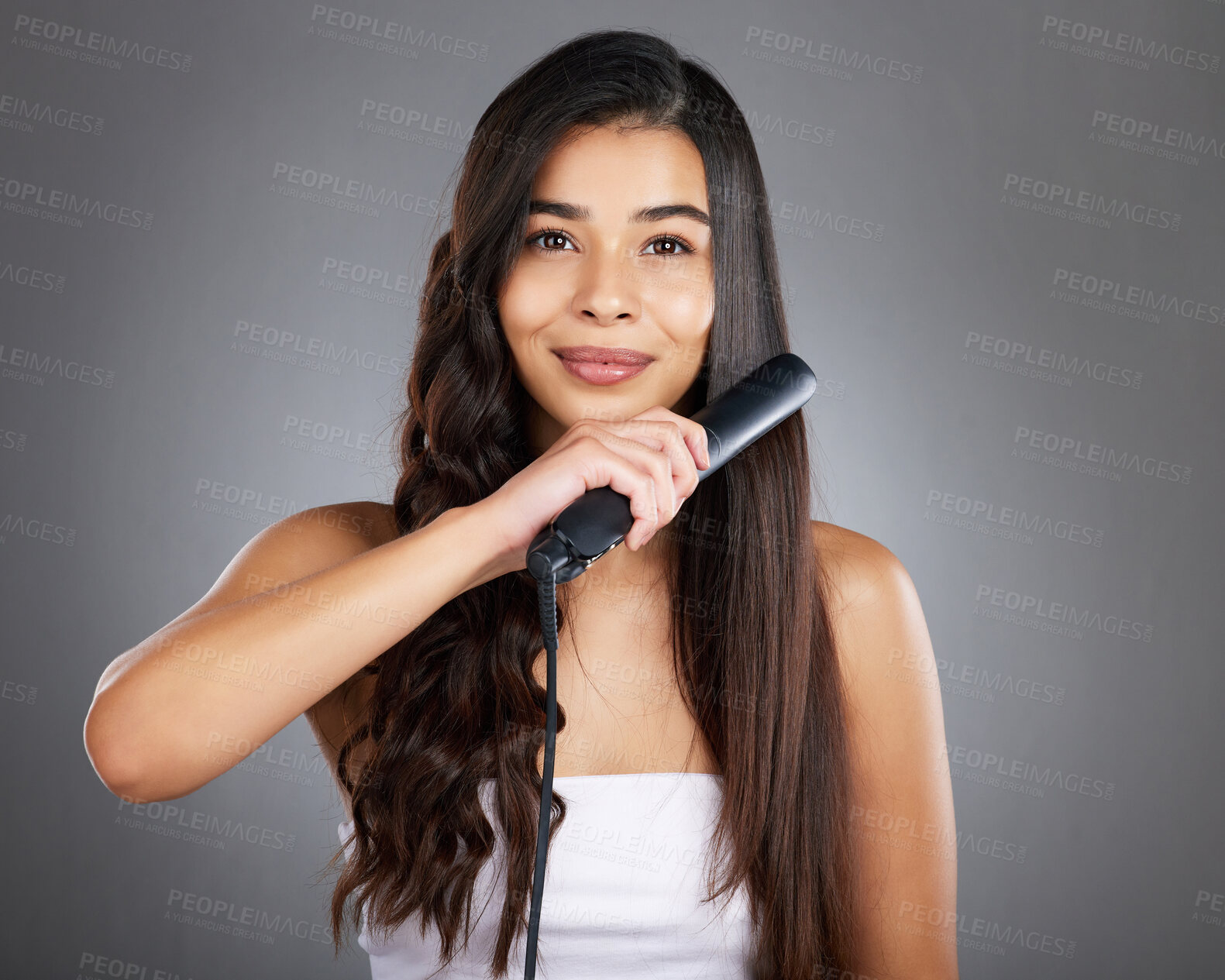 Buy stock photo Portrait, woman and hair straightener for care, natural beauty or treatment on grey studio background. Female, girl and salon equipment for luxury, ironing hair style and grooming routine for styling