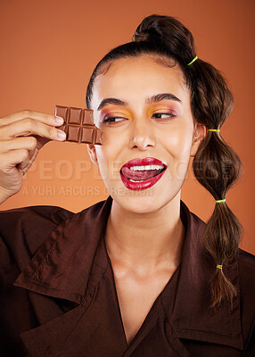Makeup, beauty and woman with face, chocolate and lipstick, tongue out and color with cosmetics. Candy, luxury and microblading with skincare, sweets with hair care and lips against studio background