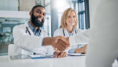 Buy stock photo Handshake, partnership or happy doctors in a meeting after successful medical surgery or reaching healthcare goals. Teamwork, woman or black man smiles shaking hands with a worker in hospital office