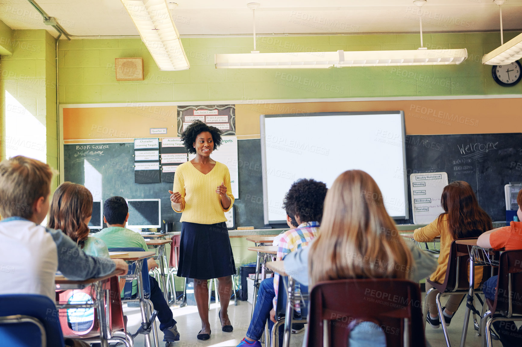 Buy stock photo Black woman, teacher and classroom with students for education, learning support and knowledge development. African female, preschool classroom and academic discussion or teaching young children 