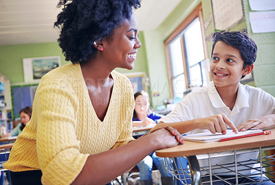 Buy stock photo Education, learning and teacher help student with assignment in elementary school. Classroom support, scholarship and happy black woman or educator aid, explaining and helping boy learner in class.