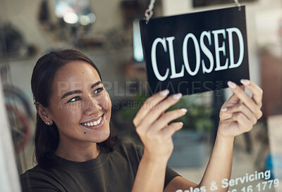Buy stock photo Shot of an attractive young woman standing and turning the sign on the door to her bicycle shop