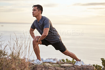 Buy stock photo Shot of a young man exercising in nature