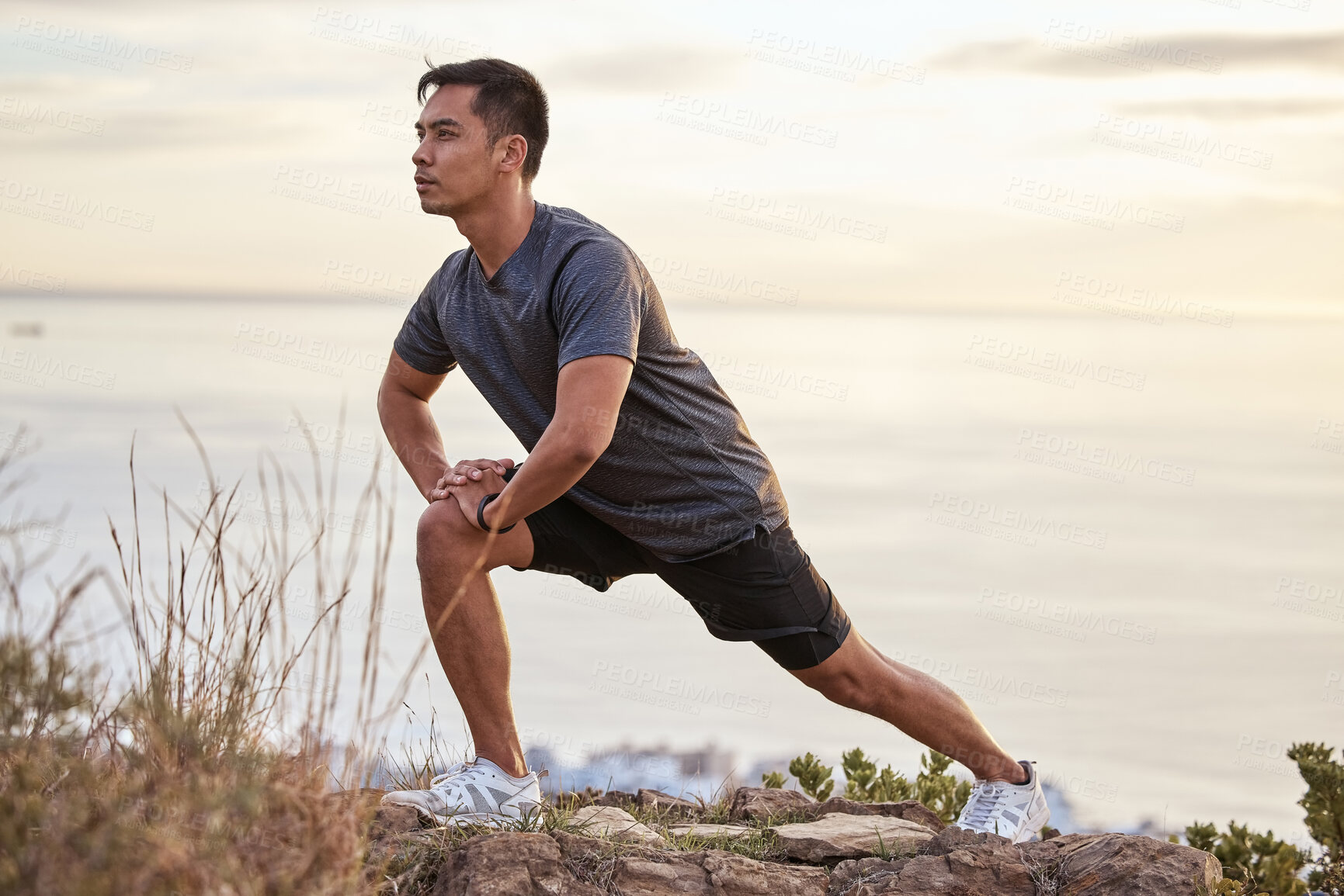 Buy stock photo Shot of a young man exercising in nature