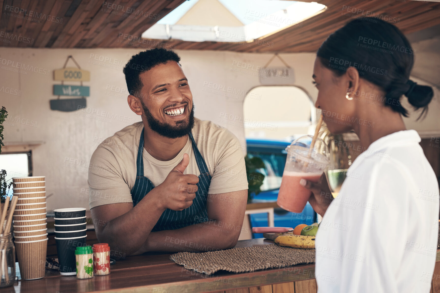 Buy stock photo Shot of a woman buying and drinking a smoothie from a food truck