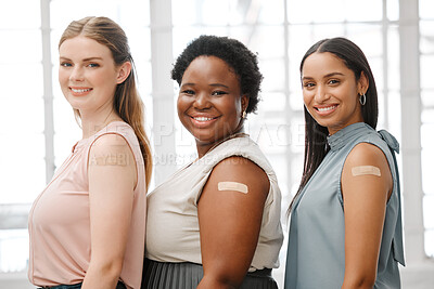 Buy stock photo Businesswoman with plaster after vaccination for business covid vaccine, safety and health protocol, protection against the virus. Smiling faces of female coworker standing together, showing support