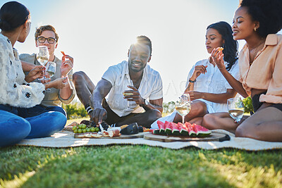 Buy stock photo Friends, travel and picnic with food and outdoor in nature, fruit and cheese for nutrition and adventure in park. Wine, sun and summer holiday with social group, diversity and young people together.