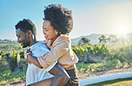 Love, black couple and piggy back in countryside, travelling and bonding for vacation, relationship and break. Romance, man carry woman and loving on weekend, holiday and honeymoon to relax and smile