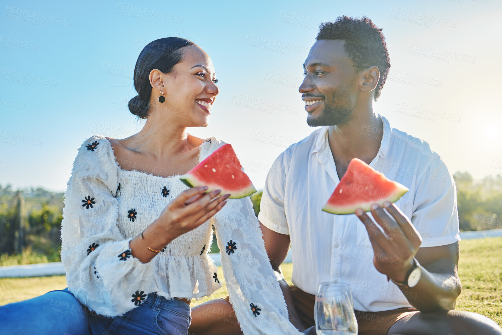 Buy stock photo Watermelon, love or black couple on a picnic to relax on a summer holiday vacation in nature or grass. Partnership, romance or happy black woman enjoys traveling or bonding with a funny black man 