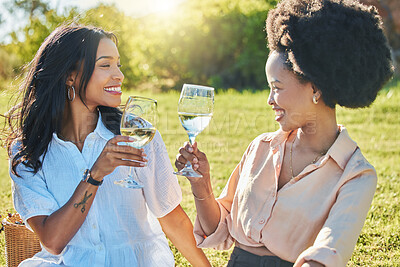 Black woman, friends and toast in park at picnic with glass, drinks or champagne for happiness in sunshine. Women, happy and celebration in summer, relax and smile together at outdoor party on grass
