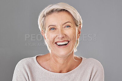 Buy stock photo Grooming, skincare and face of happy mature woman laughing against a studio grey background. Senior female feeling fresh, enjoying free time with self care hygiene treatment. Joy after routine pamper