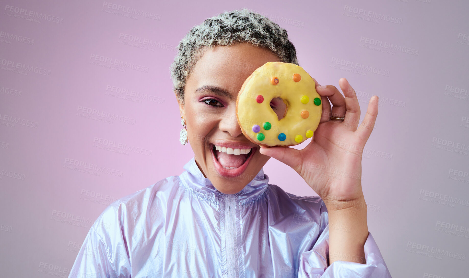 Buy stock photo Black woman, donut and fashion excited and happy peeking through dessert with futuristic vaporwave and holographic style and purple background. Face portrait of cool and trendy African female model
