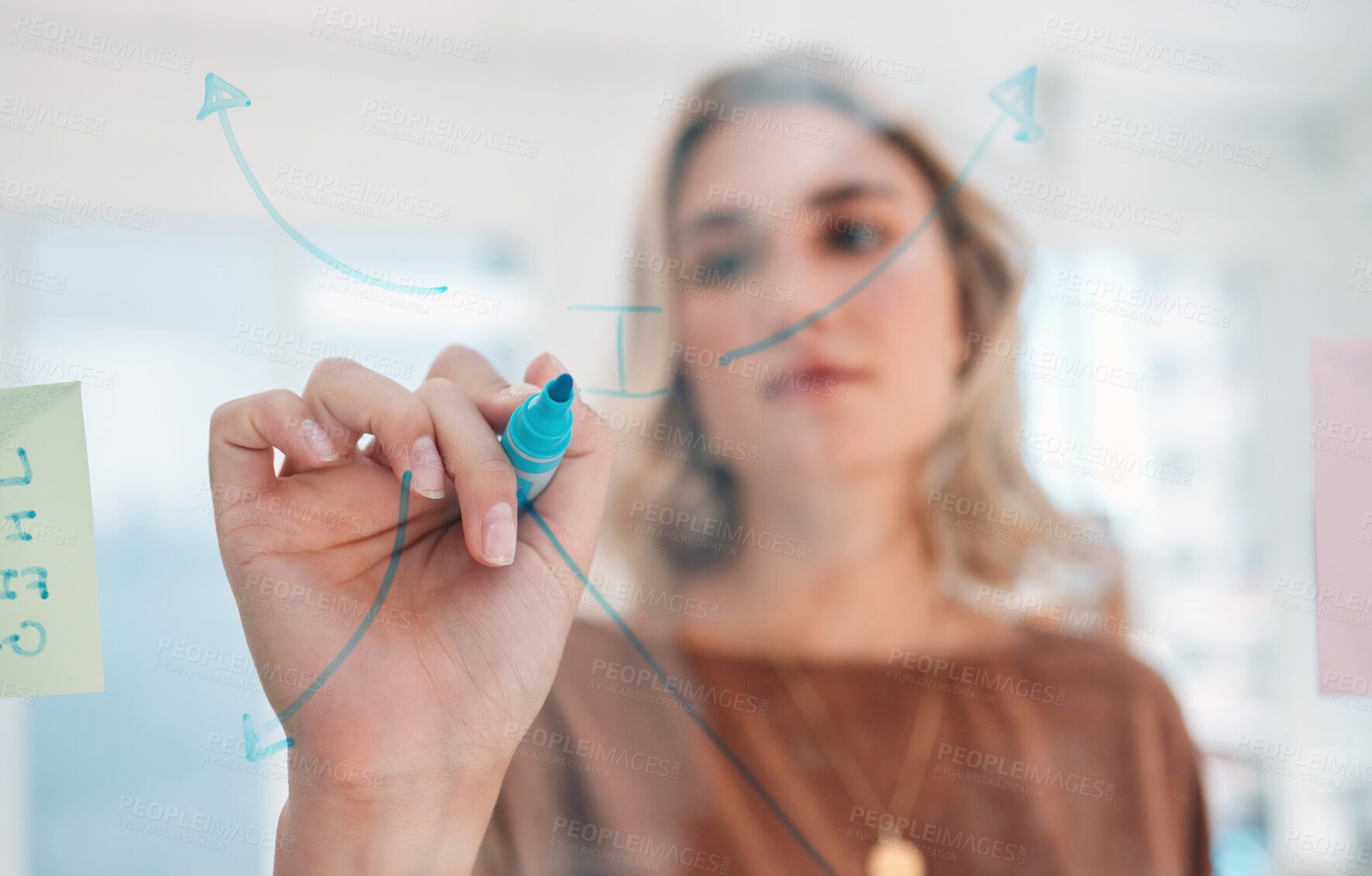 Buy stock photo Strategy, idea and woman writing on glass board with blue marker illustration at creative office. Diagram, arrow and drawing for marketing campaign employee brainstorming, planning and thinking.

