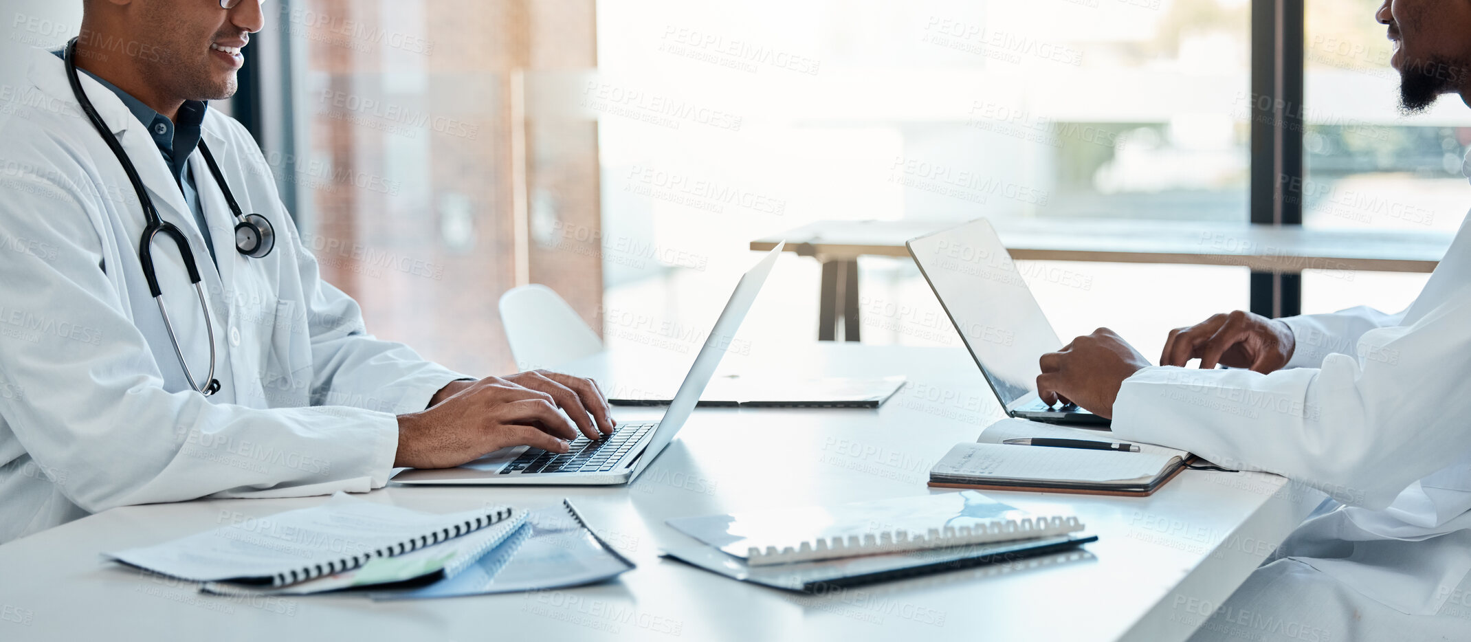 Buy stock photo Healthcare, laptop and doctors in meeting room planning surgery schedule at table in hospital boardroom. Teamwork, clinic and innovation in medical research, happy men in medicine working together.