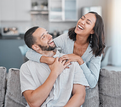 Buy stock photo Couple relax on sofa, laugh and smile together with love, support and hug partner in living room of modern apartment home. Black woman, happy man and peace in lounge with wellness bonding on a couch