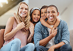 Kids, interracial and family on sofa portrait in cheerful home together in Chicago, USA. Care, hug and smile of children embracing happy mom and dad with smile for bonding in family home.