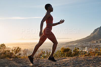 Buy stock photo Running, mountain and black woman athlete for fitness, workout or speed in morning sunrise. Nature training, run and runner for cardio exercise, performance or summer sunshine by mountains trail road