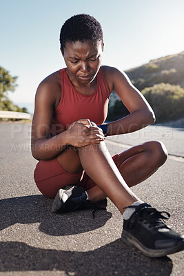 Buy stock photo Black woman, knee and sports injury on asphalt in pain from accident, exercise or run in the outdoors. African American woman suffering leg ache holding painful area, joint or bruise during workout