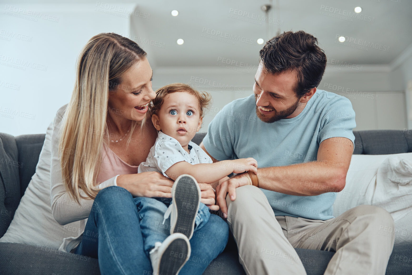 Buy stock photo Happy family, kid and parents relax on living room sofa, couch and lounge for fun, quality time and bonding together at home. Smile, happiness and parents with love, care and joy for toddler child