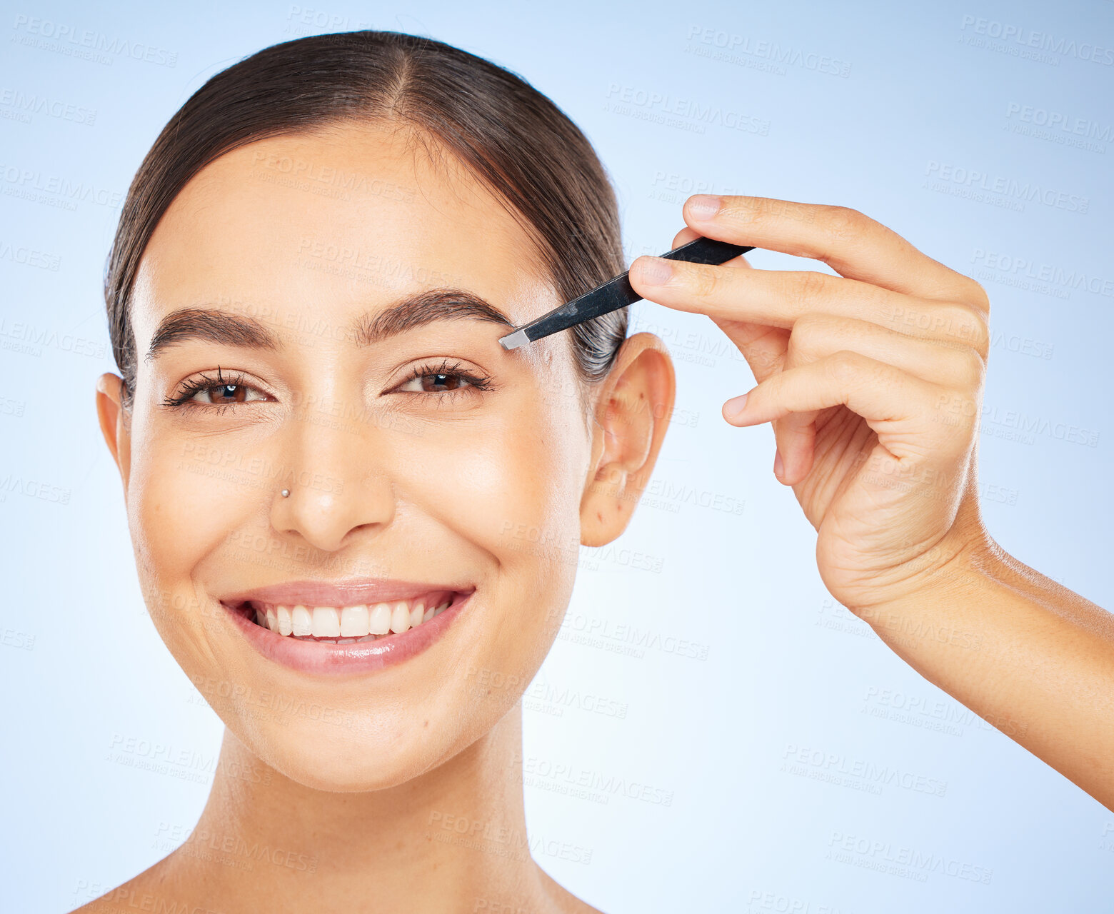 Buy stock photo Beauty, tweezers and portrait of woman on blue background, facial grooming and professional hair removal. Spa, salon and skincare, happy woman plucking or tweezing eyebrows hair.