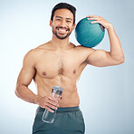 Fitness, water bottle and medicine ball with a sports man in studio for health or natural body. Portrait, face and exercise with a male athlete training for a healthy lifestyle with gym equipment