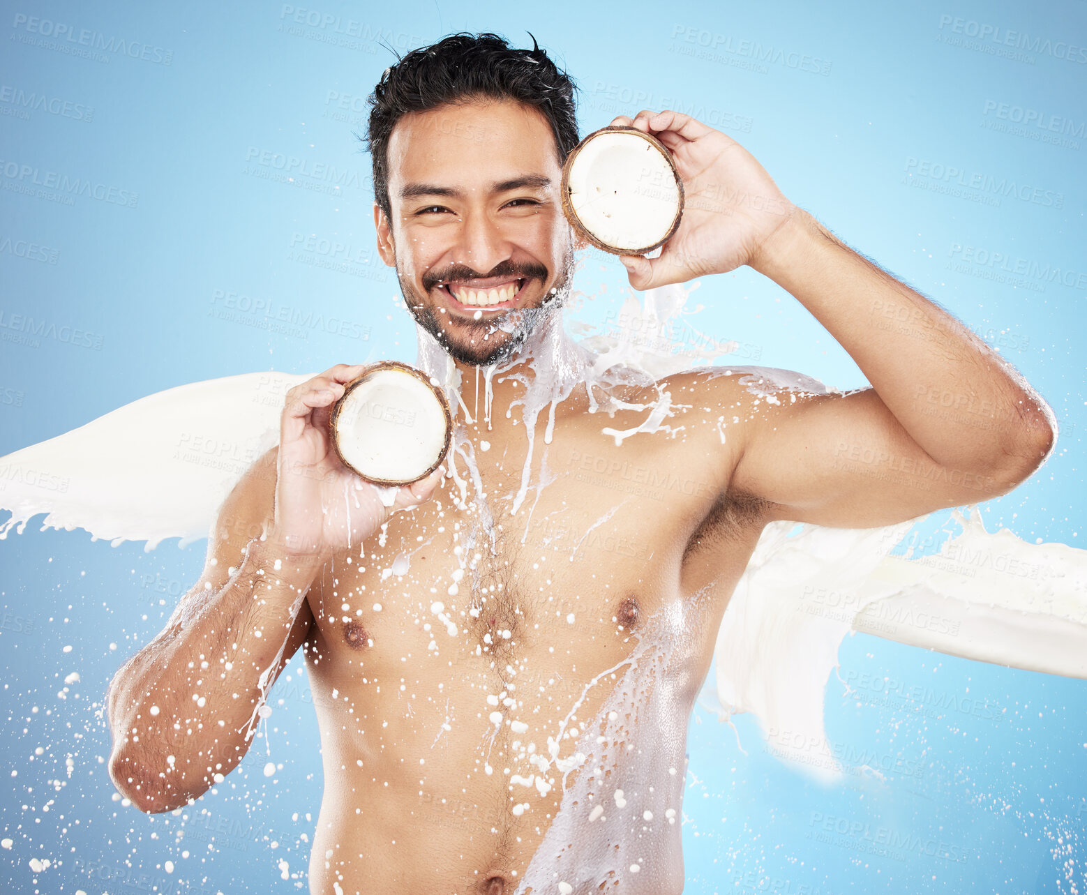 Buy stock photo Skincare man, studio and coconut in portrait for milk, splash or smile for body, face or wellness. Model, tropical and fruit for natural cosmetic moisturizer, aesthetic or skin beauty by background