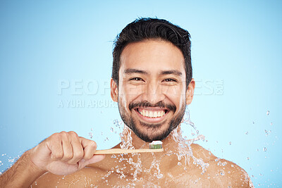 Buy stock photo Water splash, portrait or man brushing teeth in studio with toothbrush for white teeth or dental healthcare. Bamboo wood, sustainable or happy person cleaning or washing mouth with a healthy smile