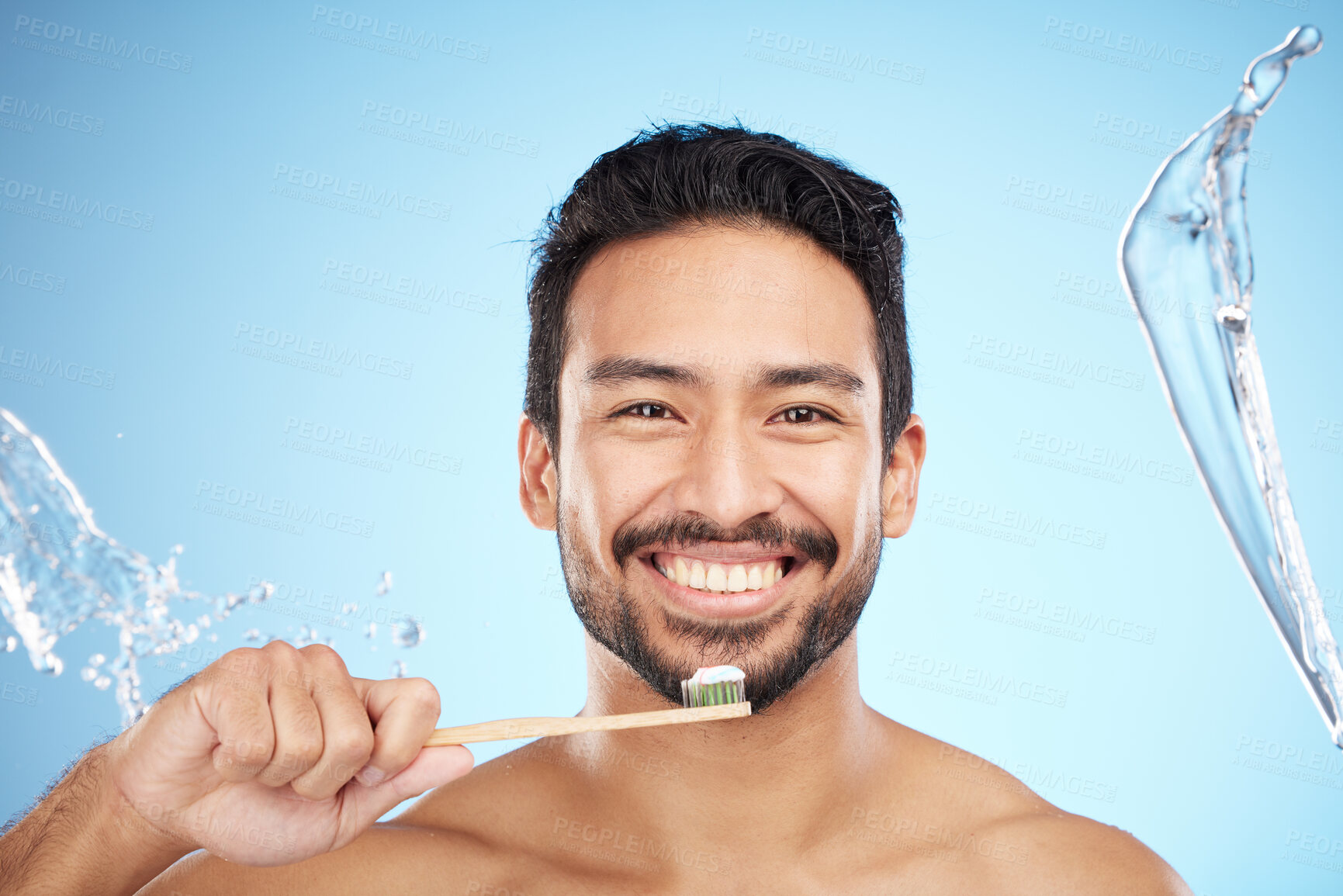 Buy stock photo Face, portrait or man brushing teeth in studio with toothbrush for white teeth or dental healthcare. Water splash, bamboo wood or happy person cleaning or washing mouth with a healthy natural smile