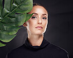 Woman, skincare and studio portrait with leaf, beauty and natural glow for cosmetics, self care or fashion. Model, cosmetic beauty and monstera leaves with dark aesthetic, face and black background