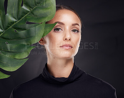Buy stock photo Woman, skincare and studio portrait with leaf, beauty and natural glow for cosmetics, self care or fashion. Model, cosmetic beauty and monstera leaves with dark aesthetic, face and black background