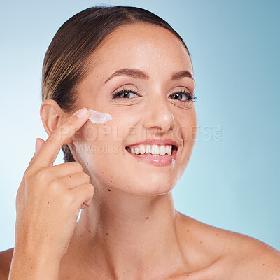 Buy stock photo Skincare, beauty and portrait of a woman with face cream for health, wellness and natural face routine. Cosmetic, happy and model with facial lotion, spf or creme isolated by a blue studio background